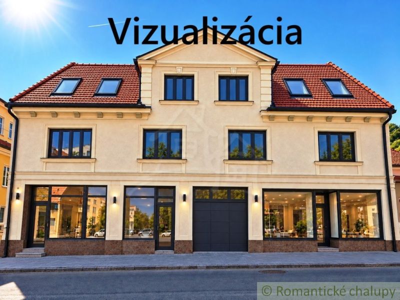 The facade of a building with commercial spaces in the town of Modrý Kameň, capturing glass display windows.