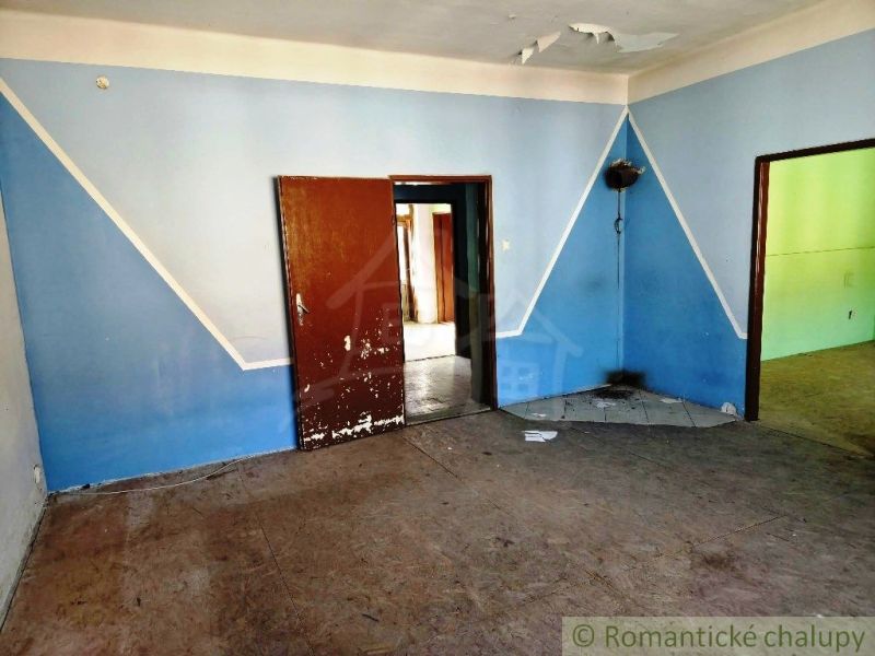 A room with blue walls and wooden doors in commercial premises.