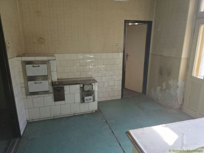 Interior of a commercial space with a traditional stove and decorated walls.