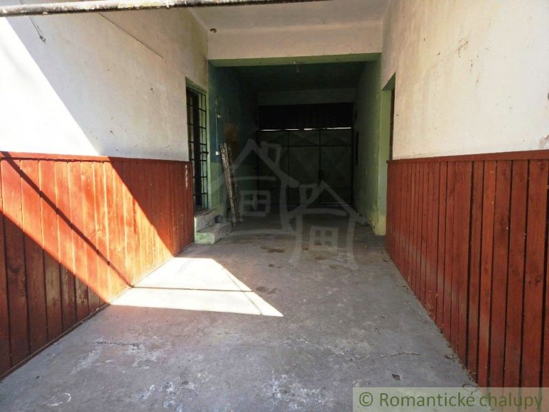 Garage in the commercial premises of Modrý Kameň with walls with wooden paneling.