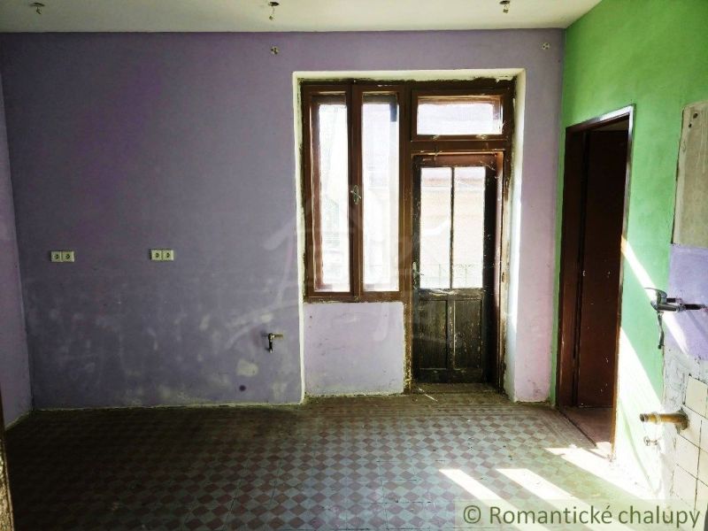 A room with colored walls and glass doors, commercial spaces.