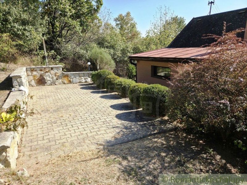 A peaceful cottage near Modrý Kameň with a terrace and landscaped greenery suitable for relaxation.