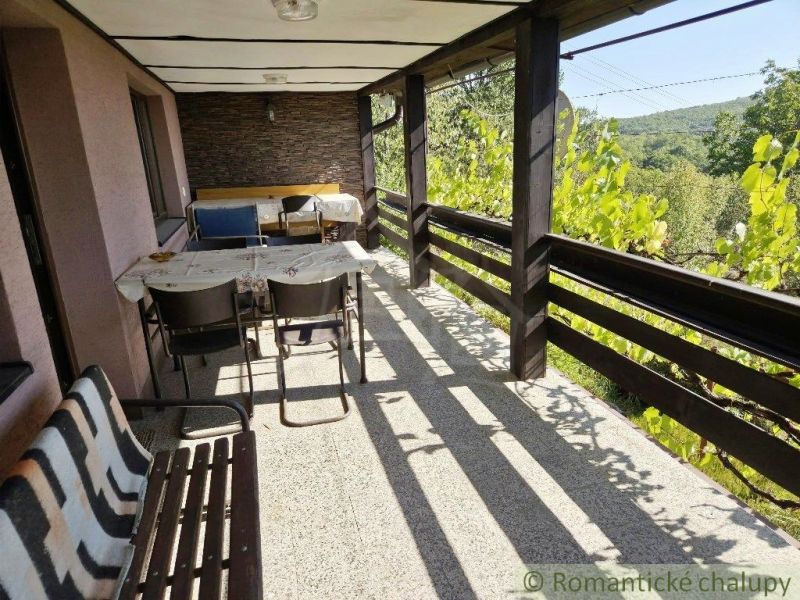 A view from the cottage in Modrý Kameň, a terrace with seating surrounded by nature.