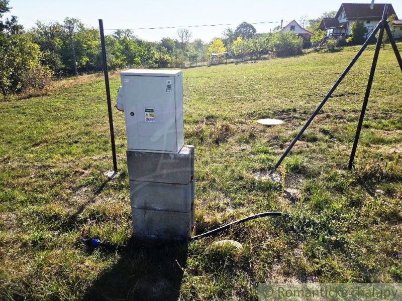 An electrical cabinet in the Gardens in Krupina on a green meadow.