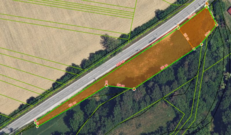 Aerial view of commercial land near the road in Modrovka with plot dimensions.