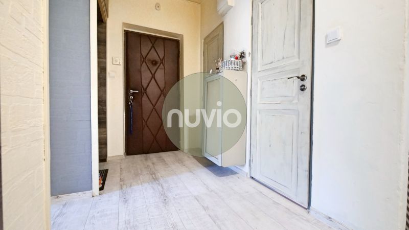 A hallway with a wooden decor floor in a 2-room apartment.
