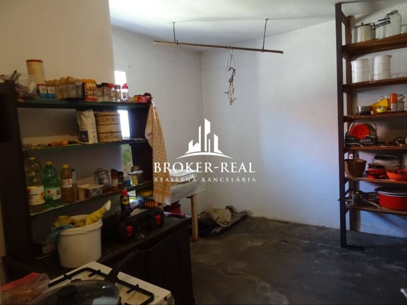 Kitchen in a family house with shelves full of kitchen utensils and ingredients.