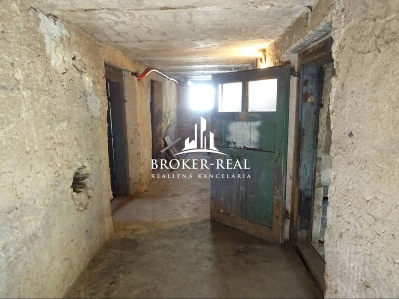 A hallway in a family house with original wooden doors and plastered walls.