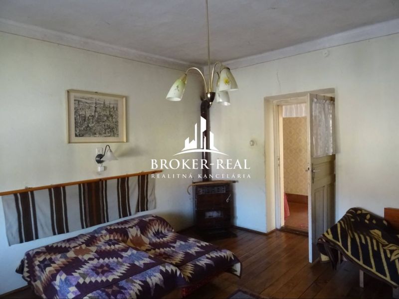 A room in a family house with a wooden decor floor and simple furnishings.
